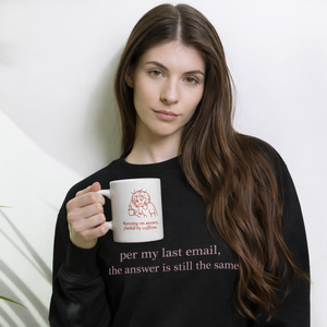 Woman holding a mug with text and a logo, wearing a black sweatshirt from 1 gurl 2 mugs "per my last email" pink text, soft cozy sweatshirt giftable. 