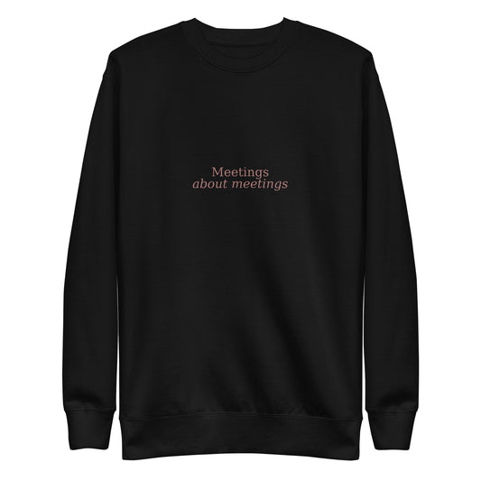 Black sweatshirt with 'Meetings about meetings' text on a white background